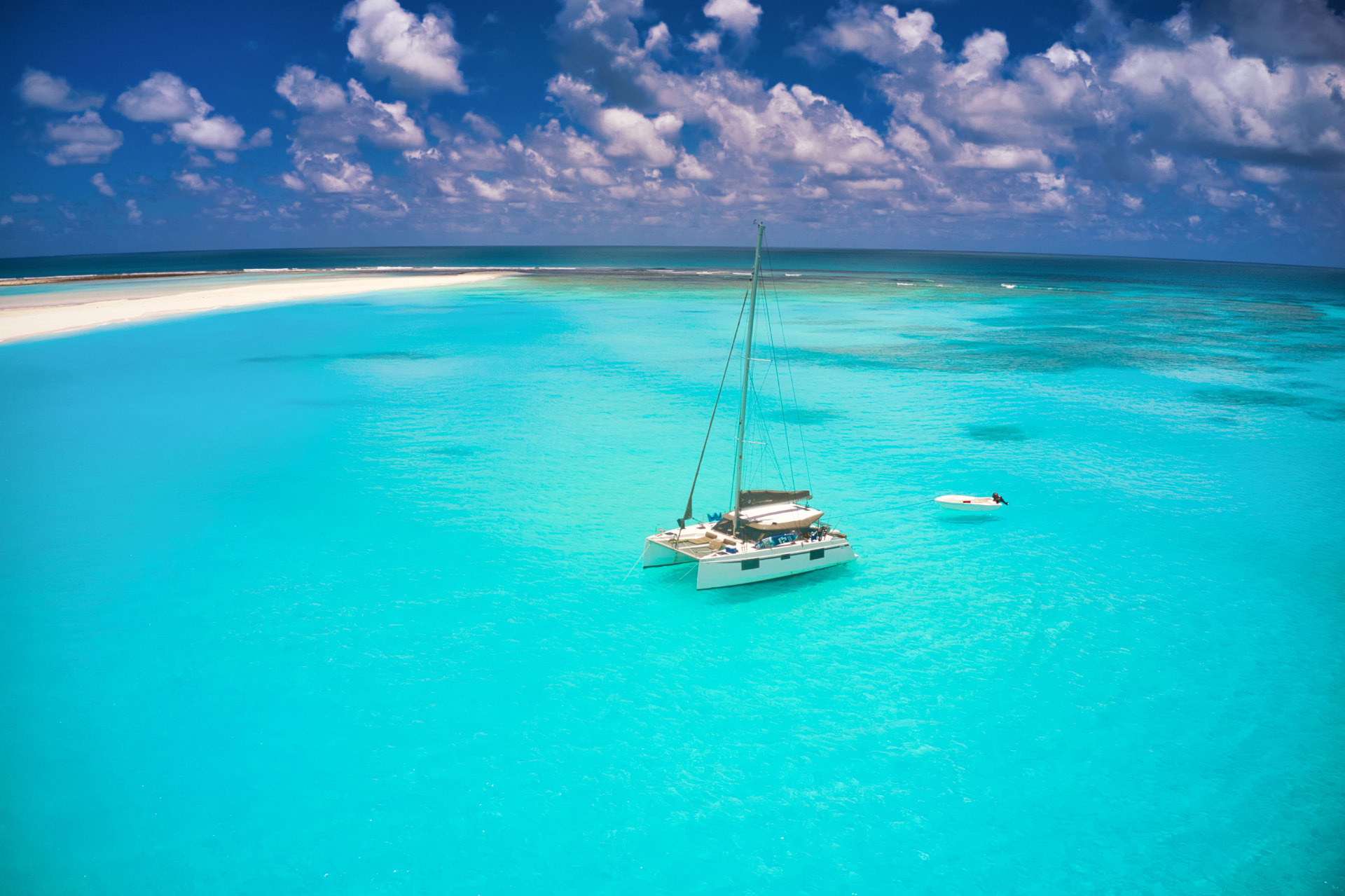Catamaran anchored off a turquoise sandbank in Mauritius